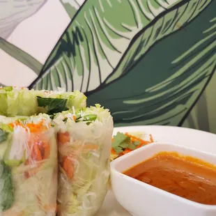 a plate of food and a bowl of sauce