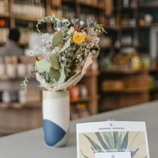 a vase of flowers on a counter
