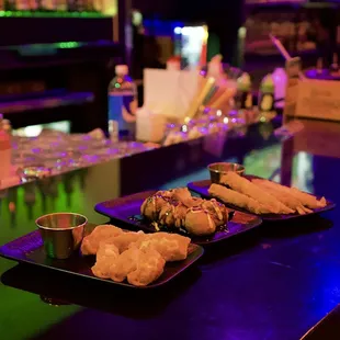 three plates of food on a bar counter