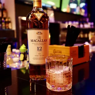 a bottle of macallan and a glass of whiskey
