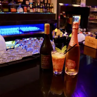 two bottles of alcohol and two glasses of alcohol