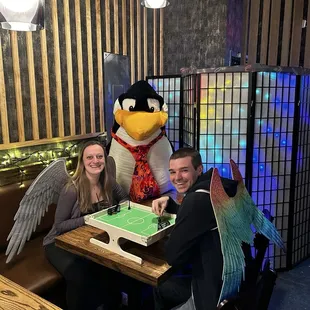 Bartender caught us wearing angel wings playing foosball with a big ole penguin