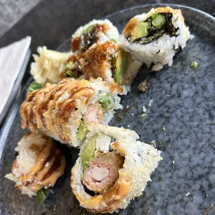 Lower: crab crunch roll (cooked), Upper: salmon skin roll (cooked)