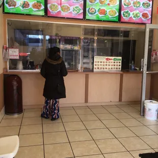 a woman standing in front of the counter