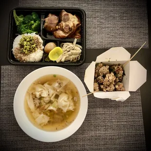 a bowl of soup and a container of meatballs