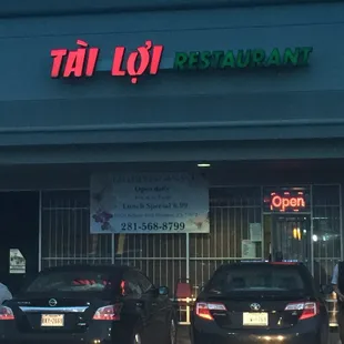 two cars parked in front of the restaurant