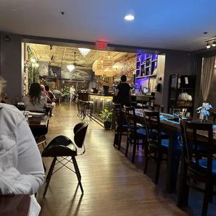 people sitting at tables in a restaurant