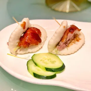 a plate of food with cucumbers