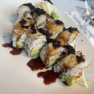 a plate of sushi with sauce on it