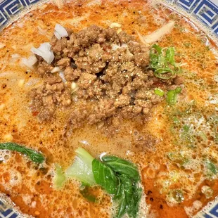 a bowl of soup with meat and vegetables