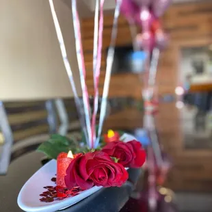 a plate with roses and candles