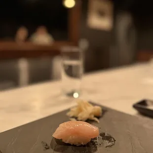 a sushi on a slate plate