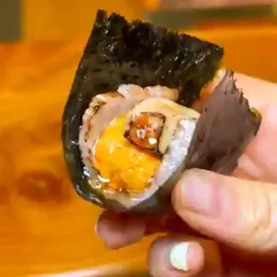 a person holding a piece of food