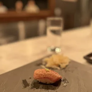 a piece of salmon on a slate plate