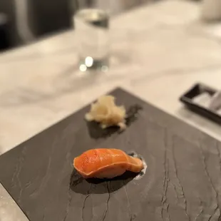 a piece of salmon on a slate plate