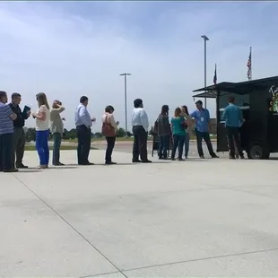 a group of people standing in a parking lot