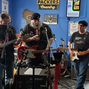 a group of men playing guitars