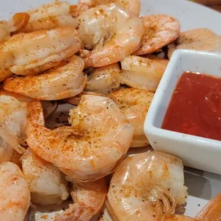 a plate of shrimp with ketchup