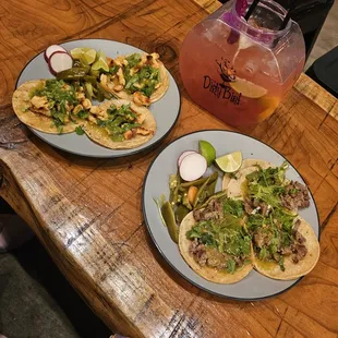 two plates of tacos on a table