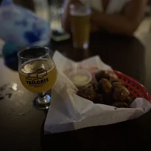  basket of fried wings and a glass of beer