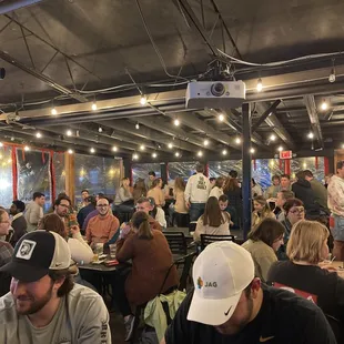 a crowd of people sitting at tables