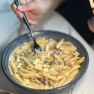 a bowl of pasta with a fork in it