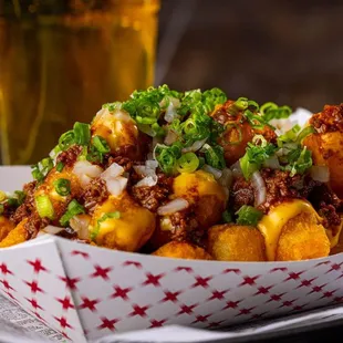 a plate of food with a glass of beer in the background