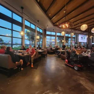 people sitting at tables in a restaurant