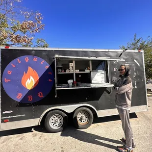 a man standing in front of a food truck