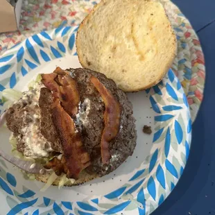 a burger with bacon and lettuce