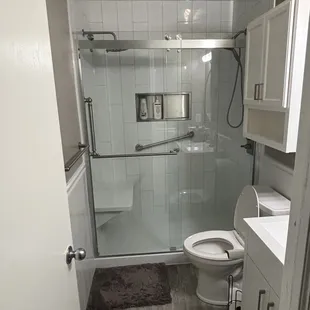 a bathroom with a shower and toilet
