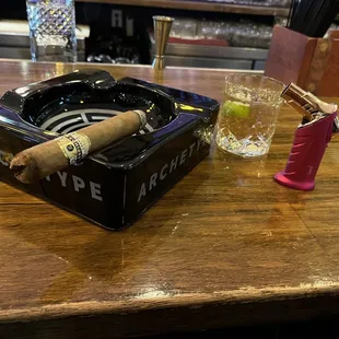 a cigar and a glass of water