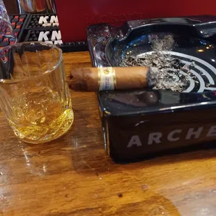a cigar and a glass of whiskey