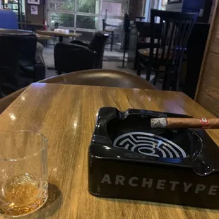 an ashtray and a glass of whiskey