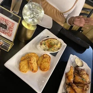  woman sitting at a table with plates of food