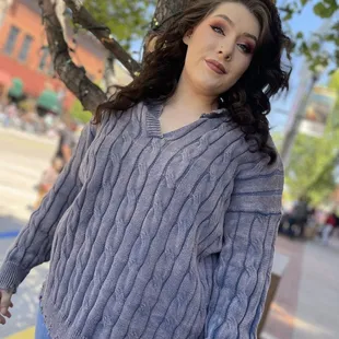 A v-neck, long sleeve relaxed fit, soft, cable knit sweater with distressed detailing.