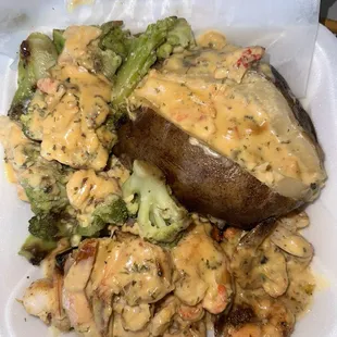 Shrimp and salmon with broccoli and a loaded seafood potato with lobster sauce