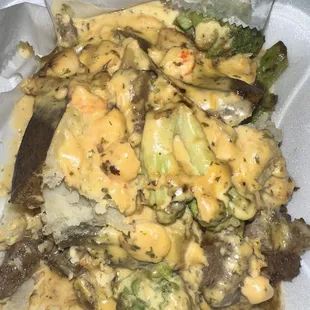 Loaded potato with salmon, shrimp and steak