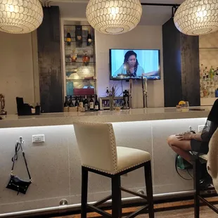 a woman sitting at a bar