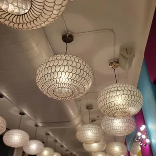 a row of lamps hanging from the ceiling