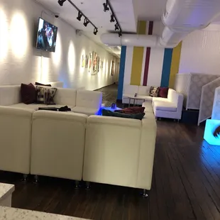 a living room with white couches