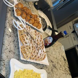 Eggs, waffles, honey butter croissants, shrimp and grits