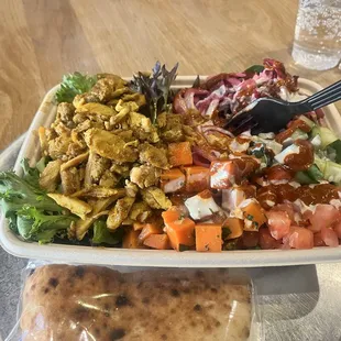 Chicken shawarma plate with super greens and pita on the side