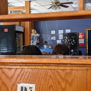 Inside. Dining room. Facing the checkout counter, looking through the partition from the street side of the restaurant.