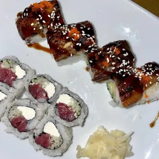 a plate of sushi and rolls