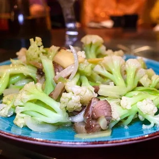 broccoli and mushrooms on a blue plate