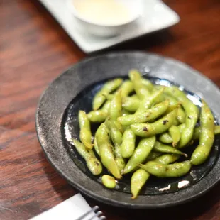 Edmame with a bit of a soy sauce marinade, slightly charred.  Very delicious