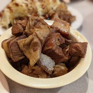 a bowl of beef and mushrooms