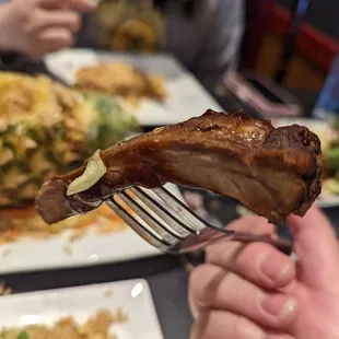 a person holding a fork over a plate of food