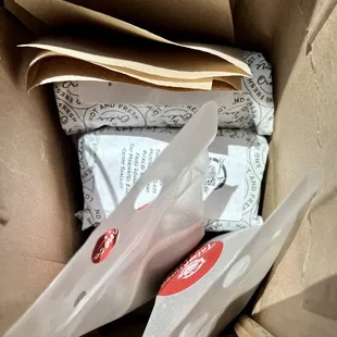 a pair of scissors in a brown paper bag